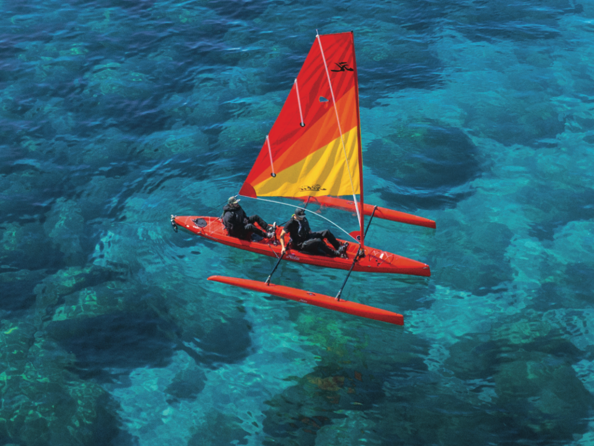 a colorful kite sitting on top of a body of water